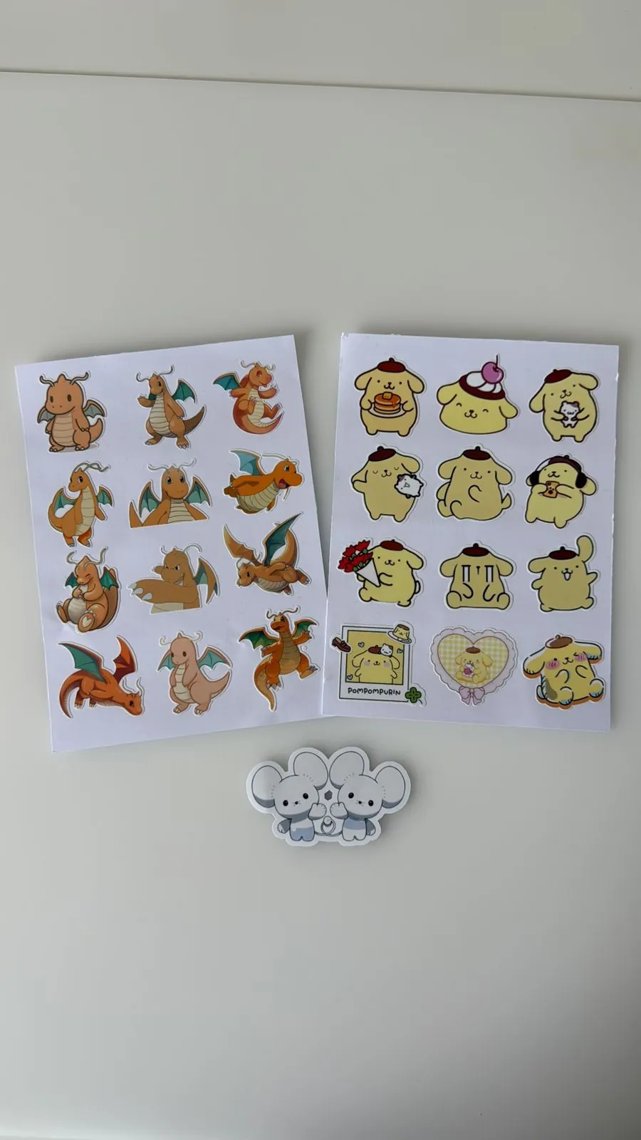 Planilla de stickers de la línea evolutiva de Dragonite y planilla de Pompompurin en vinil